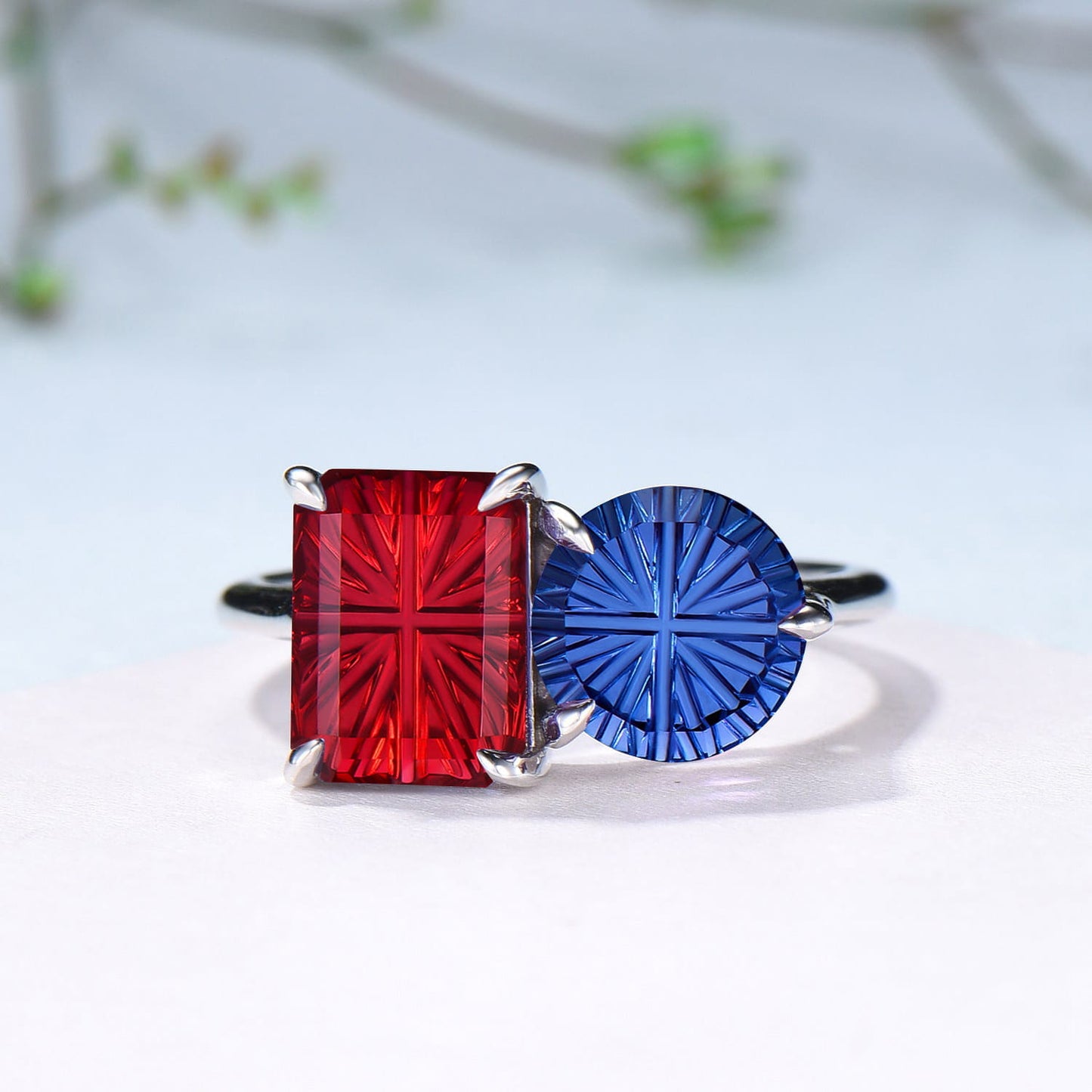 You and Me | Starburst Emerald Cut Blue Sapphire and Round Red Ruby Toi et Moi Engagement Ring