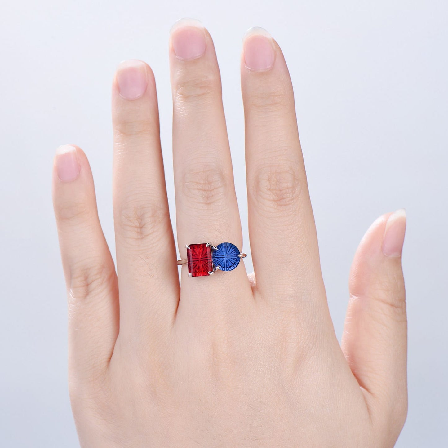 You and Me | Starburst Emerald Cut Blue Sapphire and Round Red Ruby Toi et Moi Engagement Ring