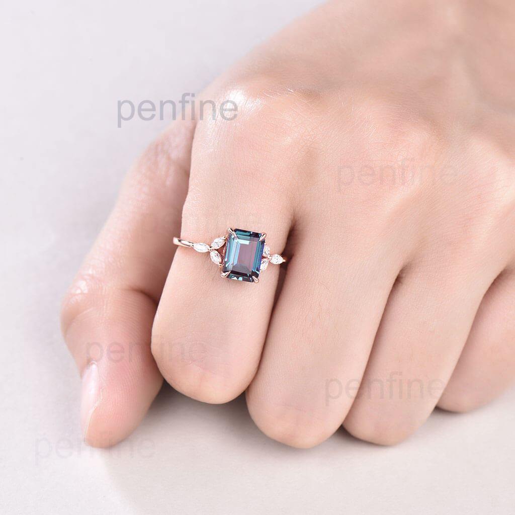 Emerald cut Alexandrite engagement ring rose gold in hand