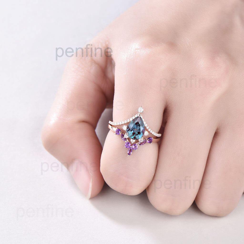 alexandrite engagement ring and amethyst band in hand