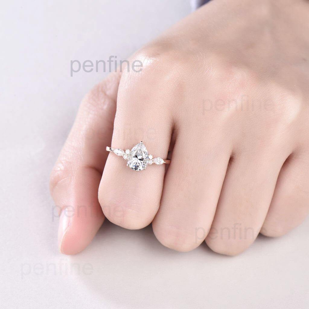 pear moissanite ring in hand